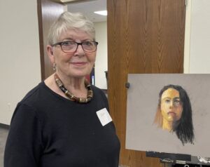 June Holloway and her portrait in progress